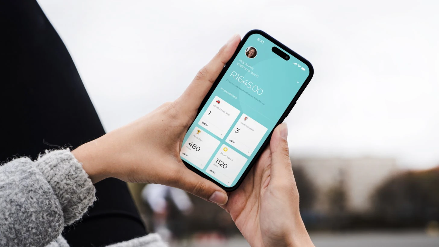 A person holding a phone showing a welcome screen
