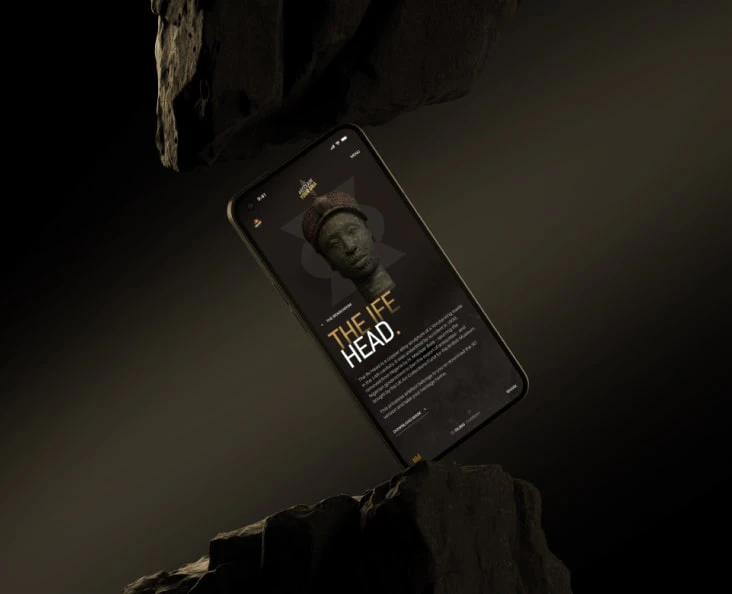A phone displaying an app diagonally between two rocks