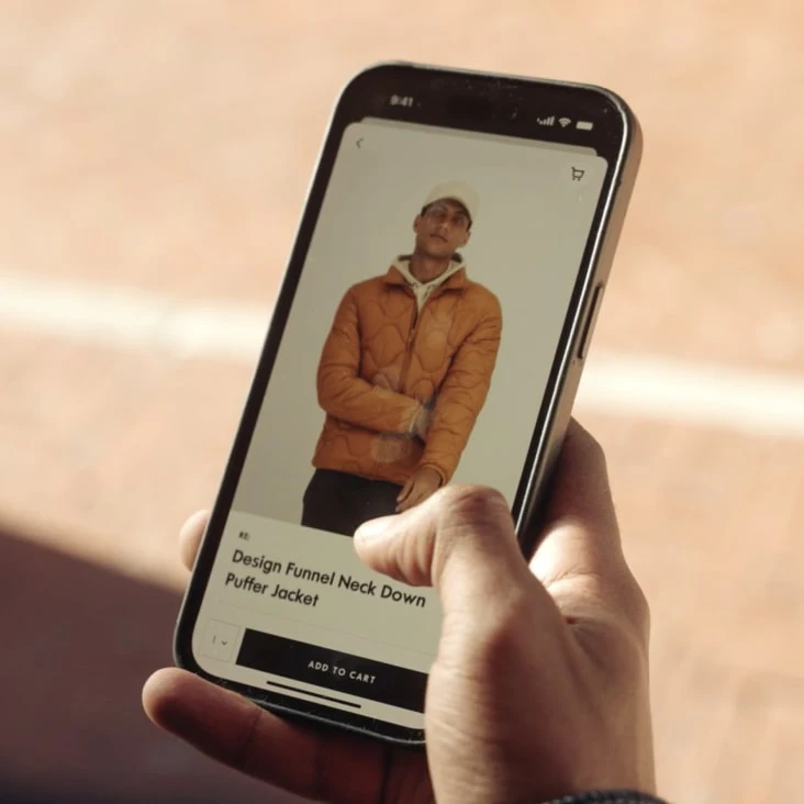 Hand tapping an add-to-cart button on a phone